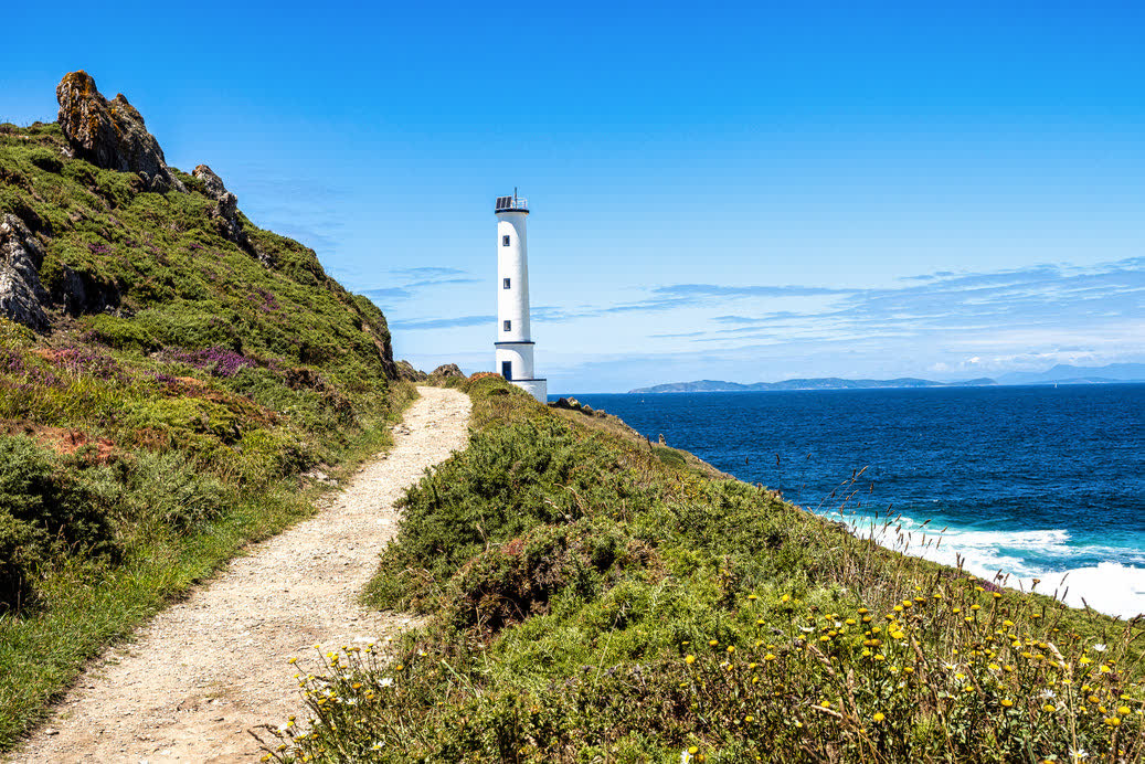 A path to a lighthouse on the Galician coast